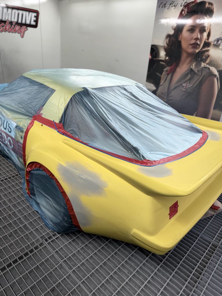 Historic RX-7 race car masked for respray in the MRP Automotive downdraft spray booth