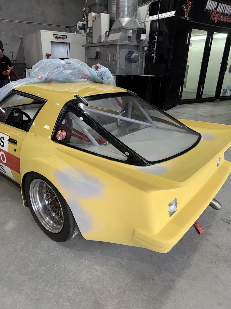 RX-7 race car in primer during body preparation at the MRP Automotive workshop