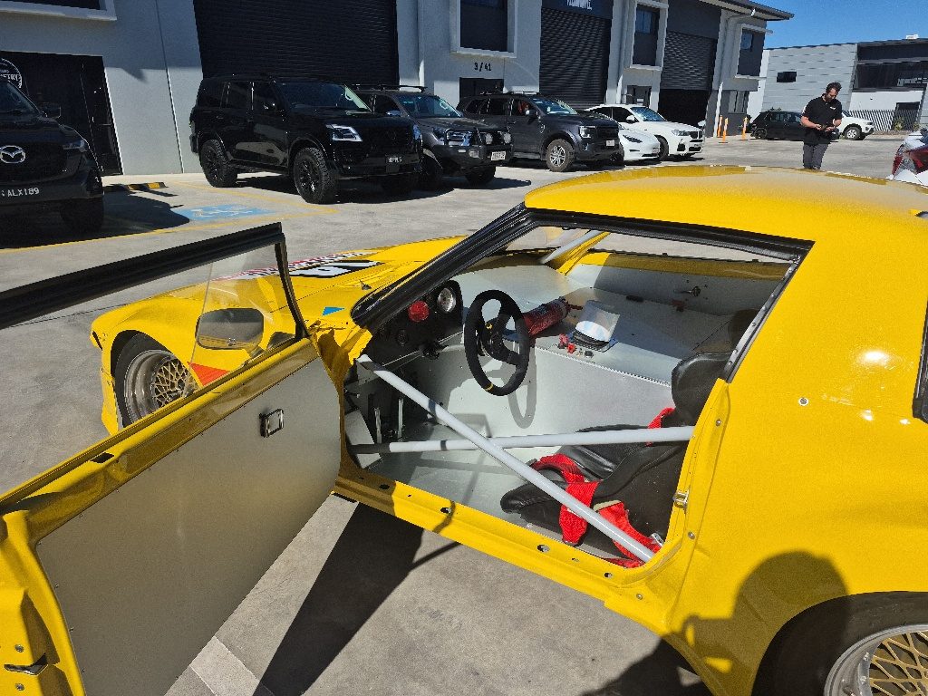 Roll cage and race interior of the RX-7 with freshly painted door jambs